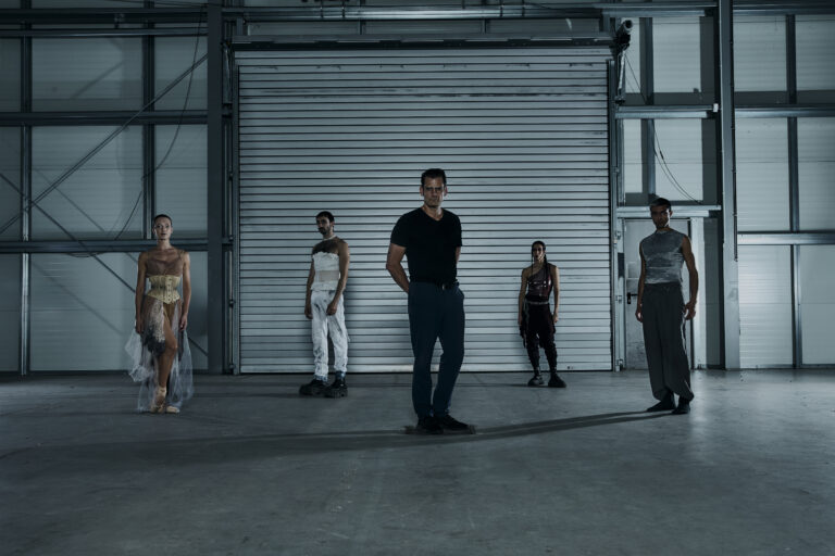 Norman Nodge (centre) and Metaxy cast in avant-garde costumes posing in House 12 at Atelier Gardens, Berlin